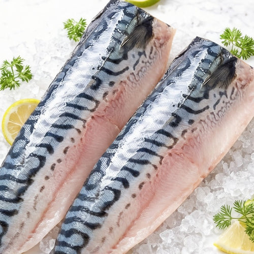 Two silver-blue mackerel fillets resting on crushed ice with lemon