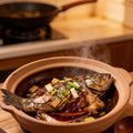 Braised grouper in a clay pot with ginger and scallion